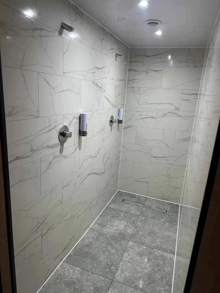 Clean shower room with tiled walls
